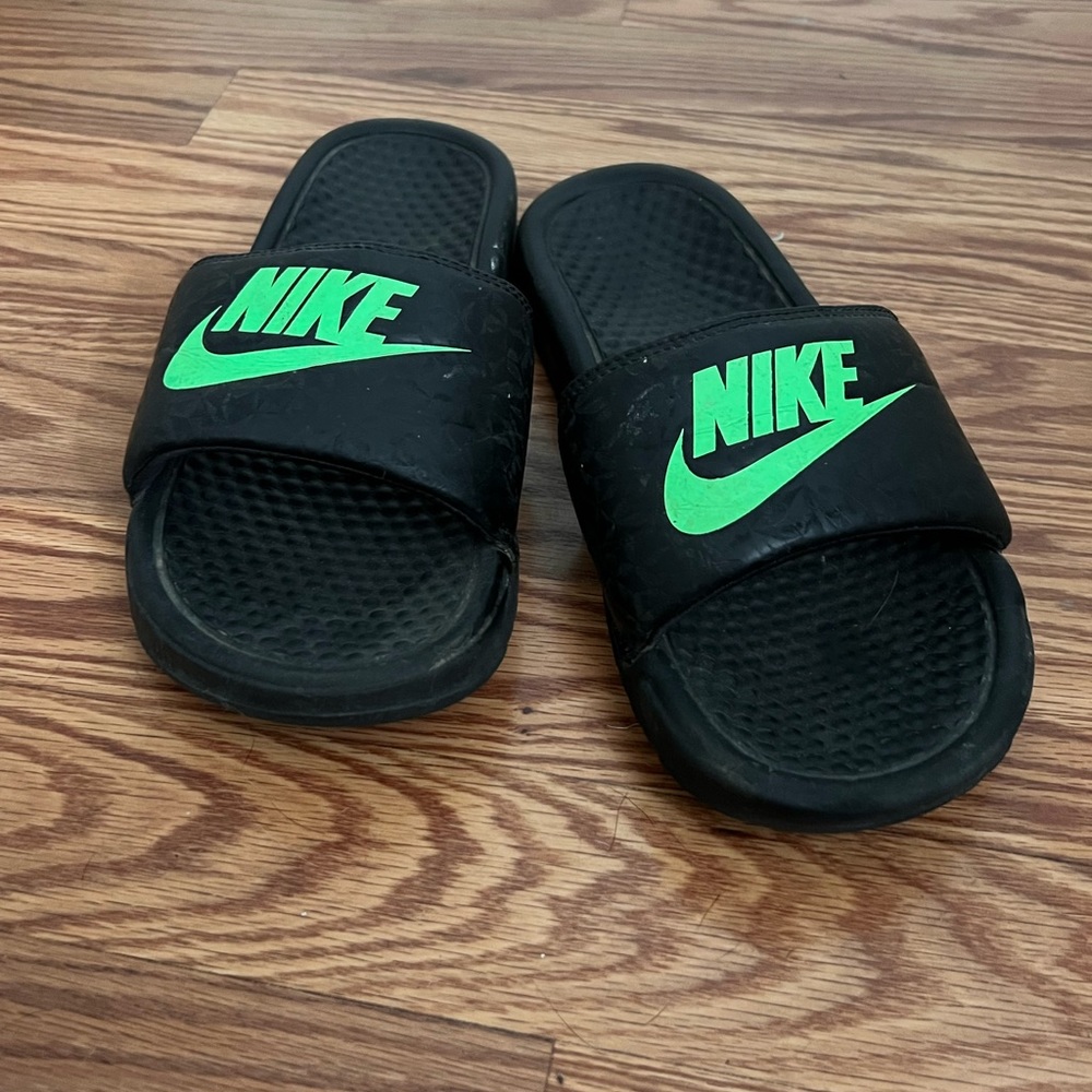 Lime green and black Nike slides